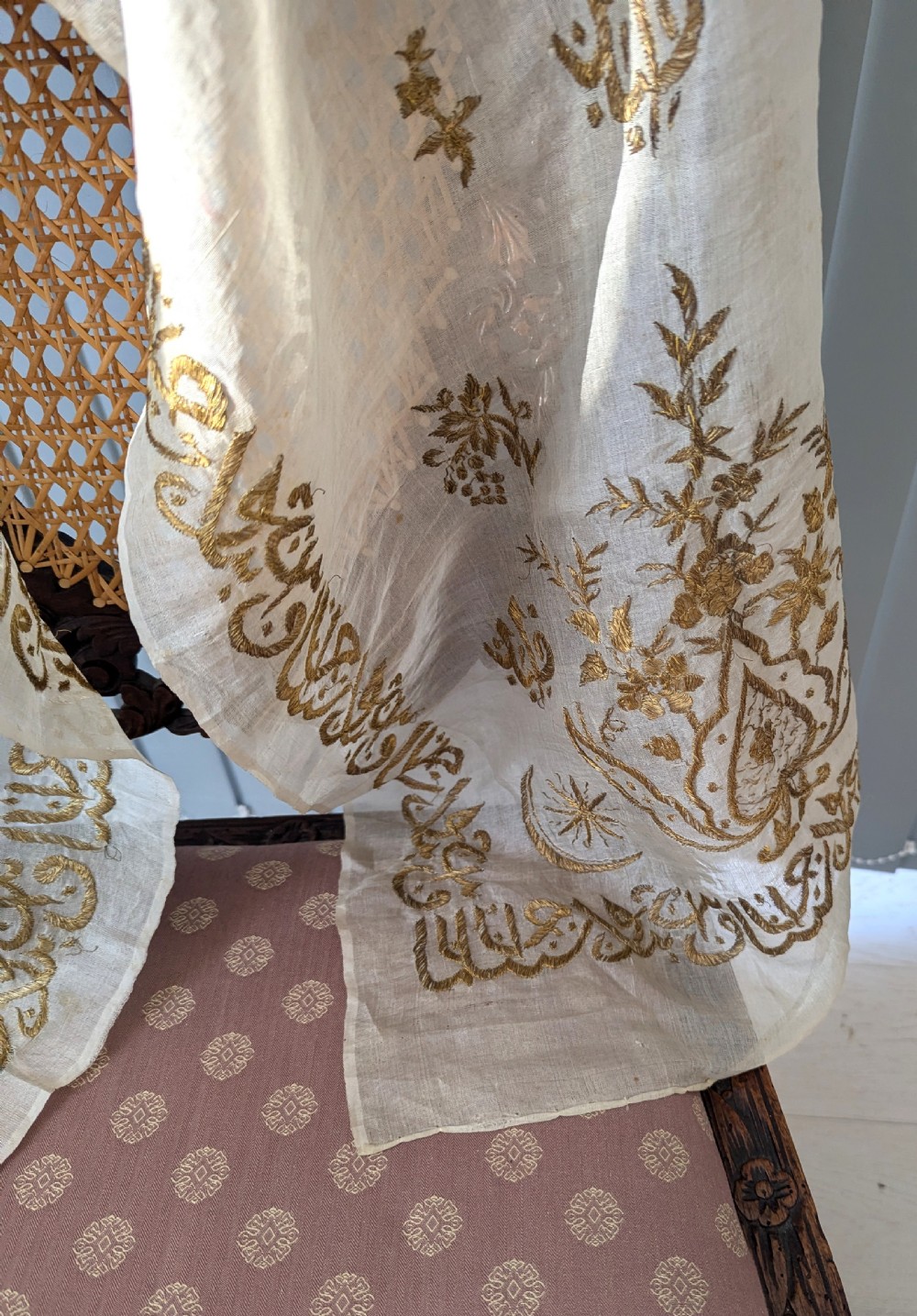 A light cream silk scarf featuring metallic gold thread hand embroidery with floral motifs, crescent symbols, and calligraphic borders. View VI