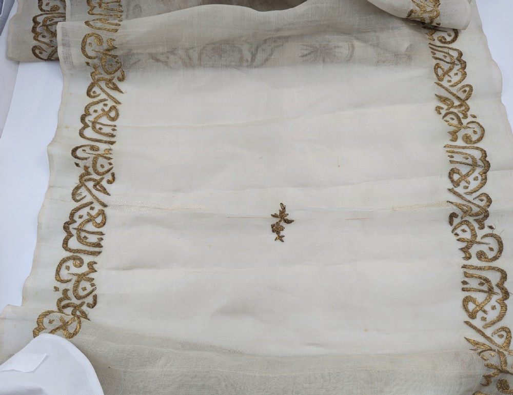 A light cream silk scarf featuring metallic gold thread hand embroidery with floral motifs, crescent symbols, and calligraphic borders. View VIII