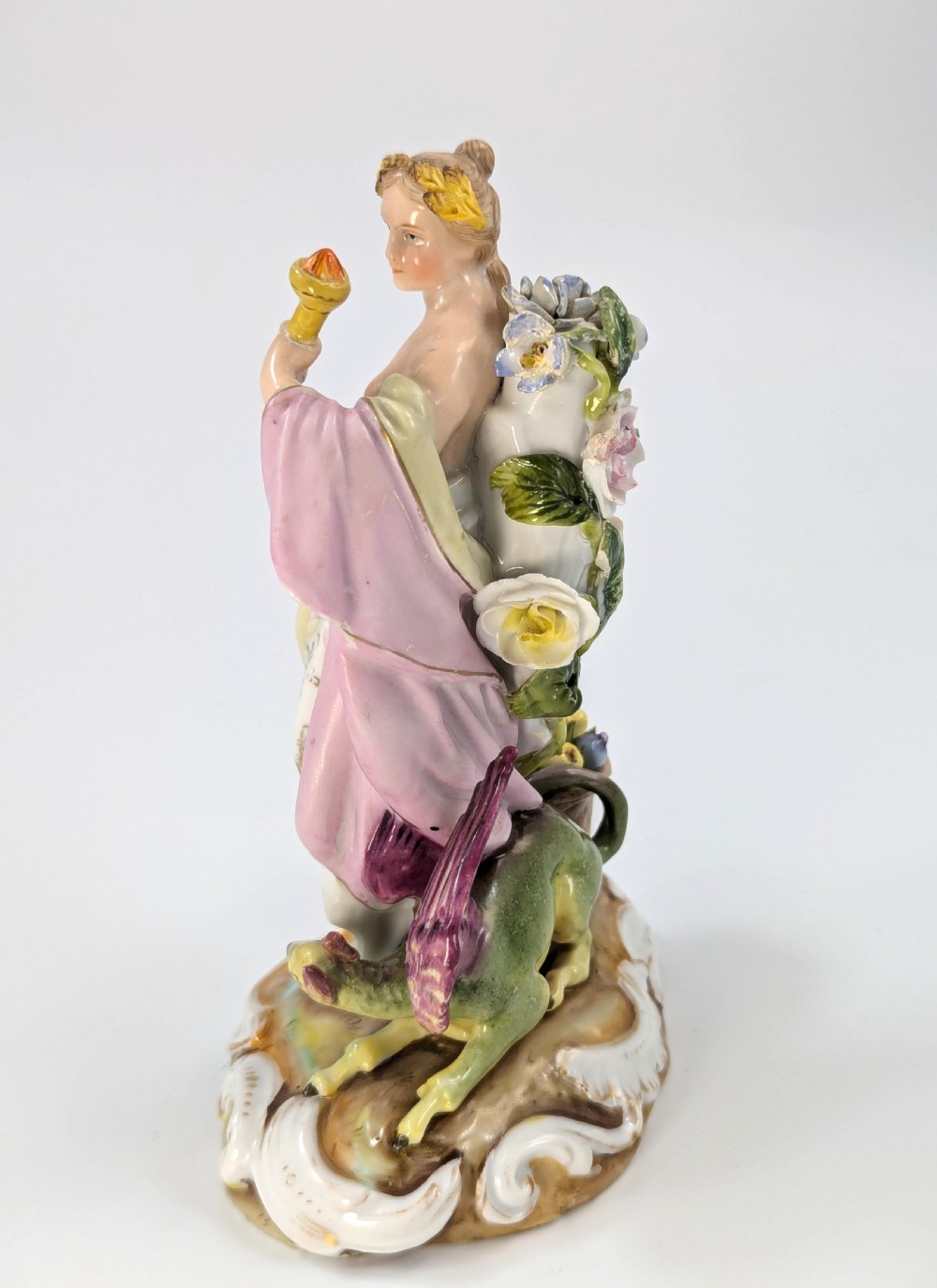 Late 19th-century German Volkstedt porcelain allegorical figurine depicting a draped female figure holding a torch and sheaf of wheat atop a gilded scroll base. View II