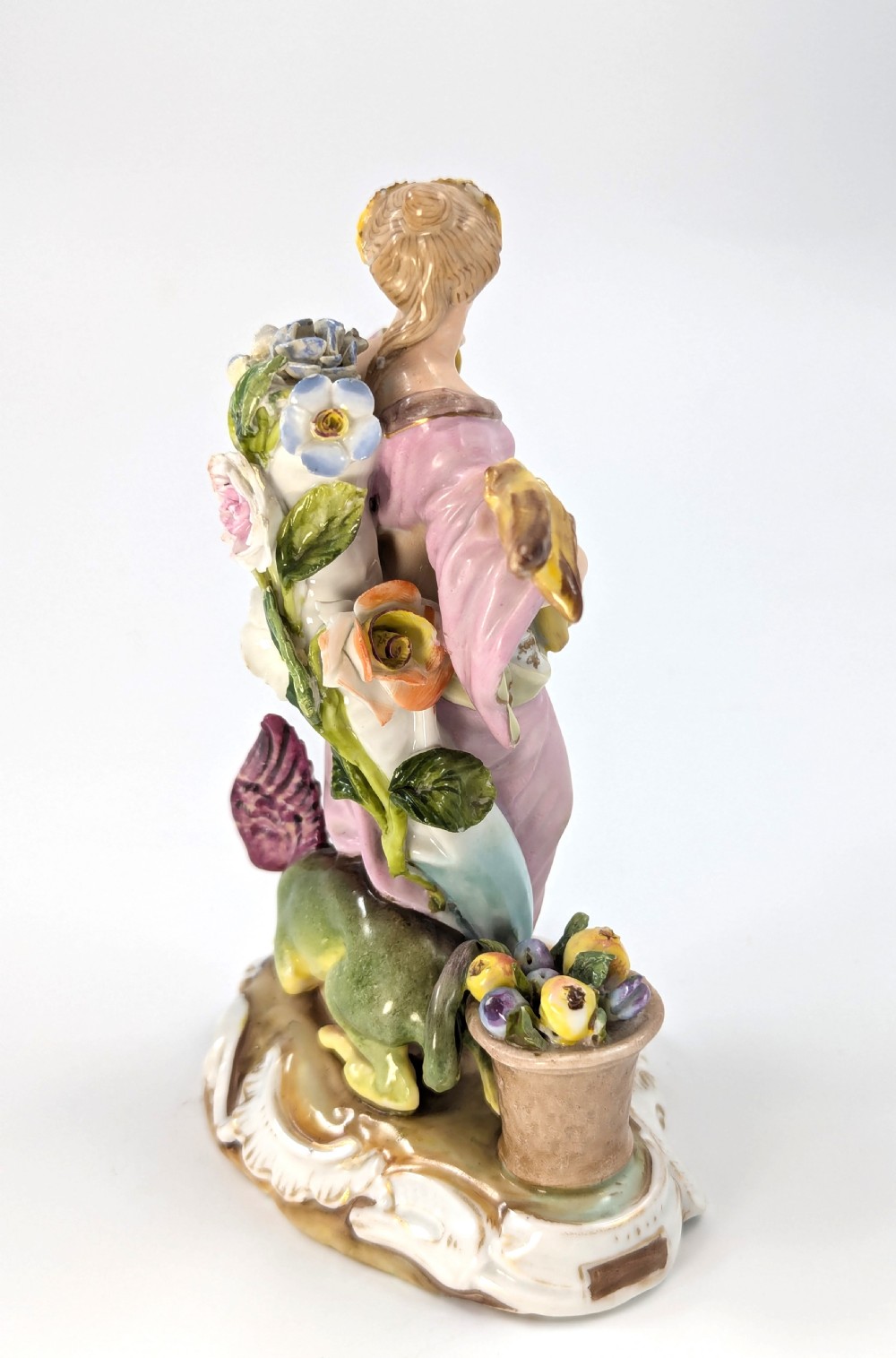 Late 19th-century German Volkstedt porcelain allegorical figurine depicting a draped female figure holding a torch and sheaf of wheat atop a gilded scroll base. View IV