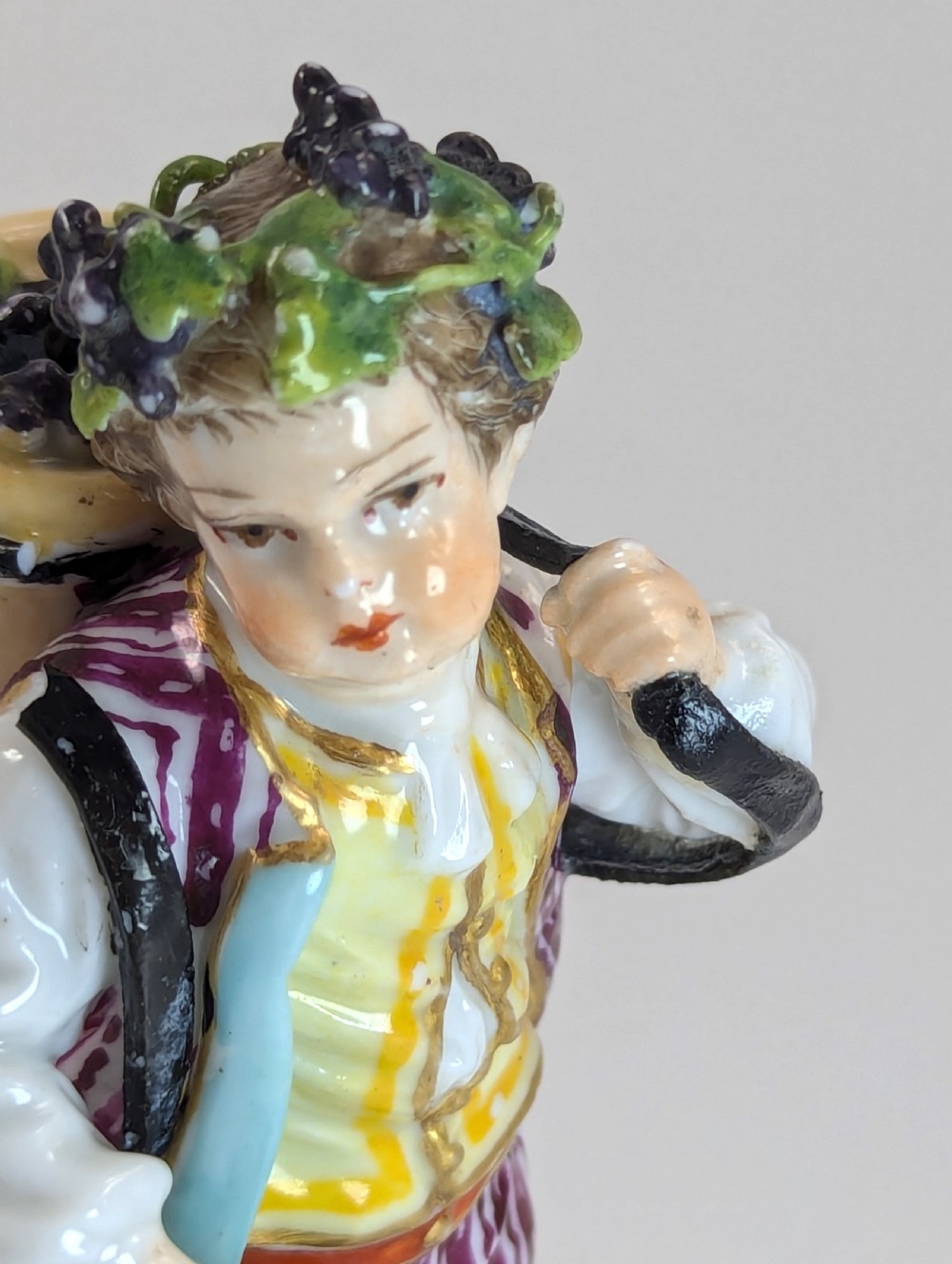 Pair of late 19th-century Helena Wolfsohn porcelain child figurines featuring hand-painted floral attire, baskets, and gilded bases. View VI