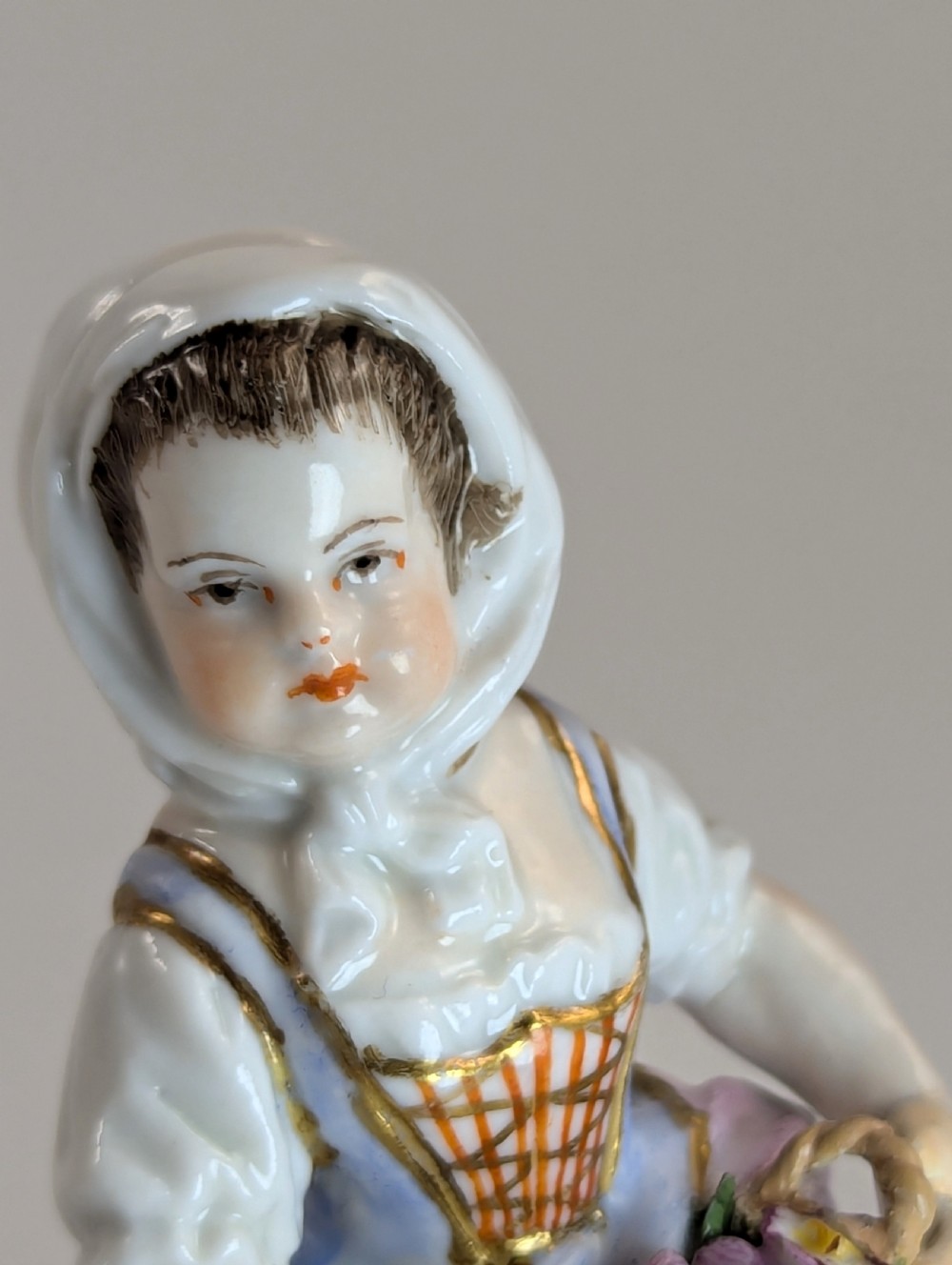 Pair of late 19th-century Helena Wolfsohn porcelain child figurines featuring hand-painted floral attire, baskets, and gilded bases. View VIII
