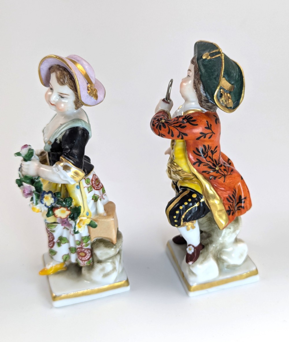 A pair of early 19th-century Chelsea-style hand-painted porcelain figurines depicting a female gardener and a male farmer with gilded accents. View II