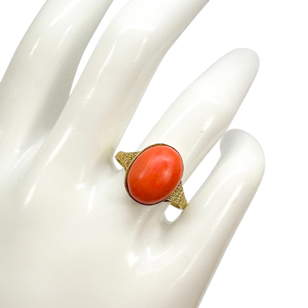 Art Deco 8ct gold ring with 6.65ct oval coral, c.1920