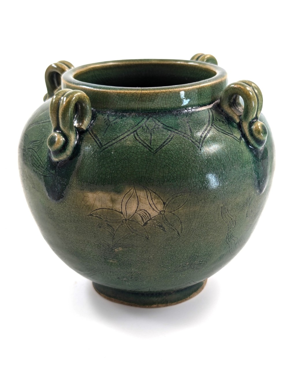 A rounded olive green celadon ceramic jar with four loop handles along the rim, featuring crackle glaze and incised line drawings of ducks and lotus plants. View II