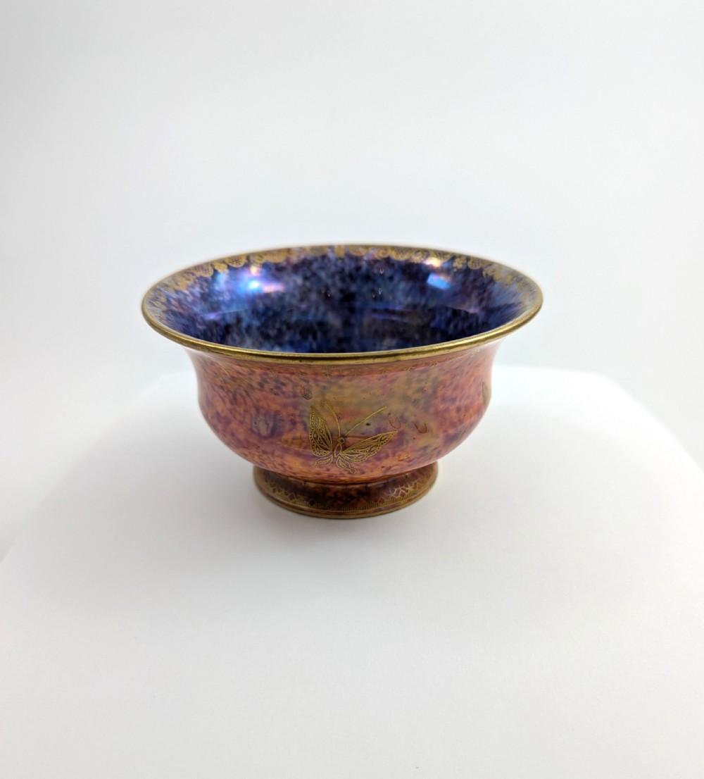 An antique Wedgwood ceramic bowl featuring a mottled orange and pink exterior with gilded butterfly motifs and an iridescent purple and blue interior glaze. View IV