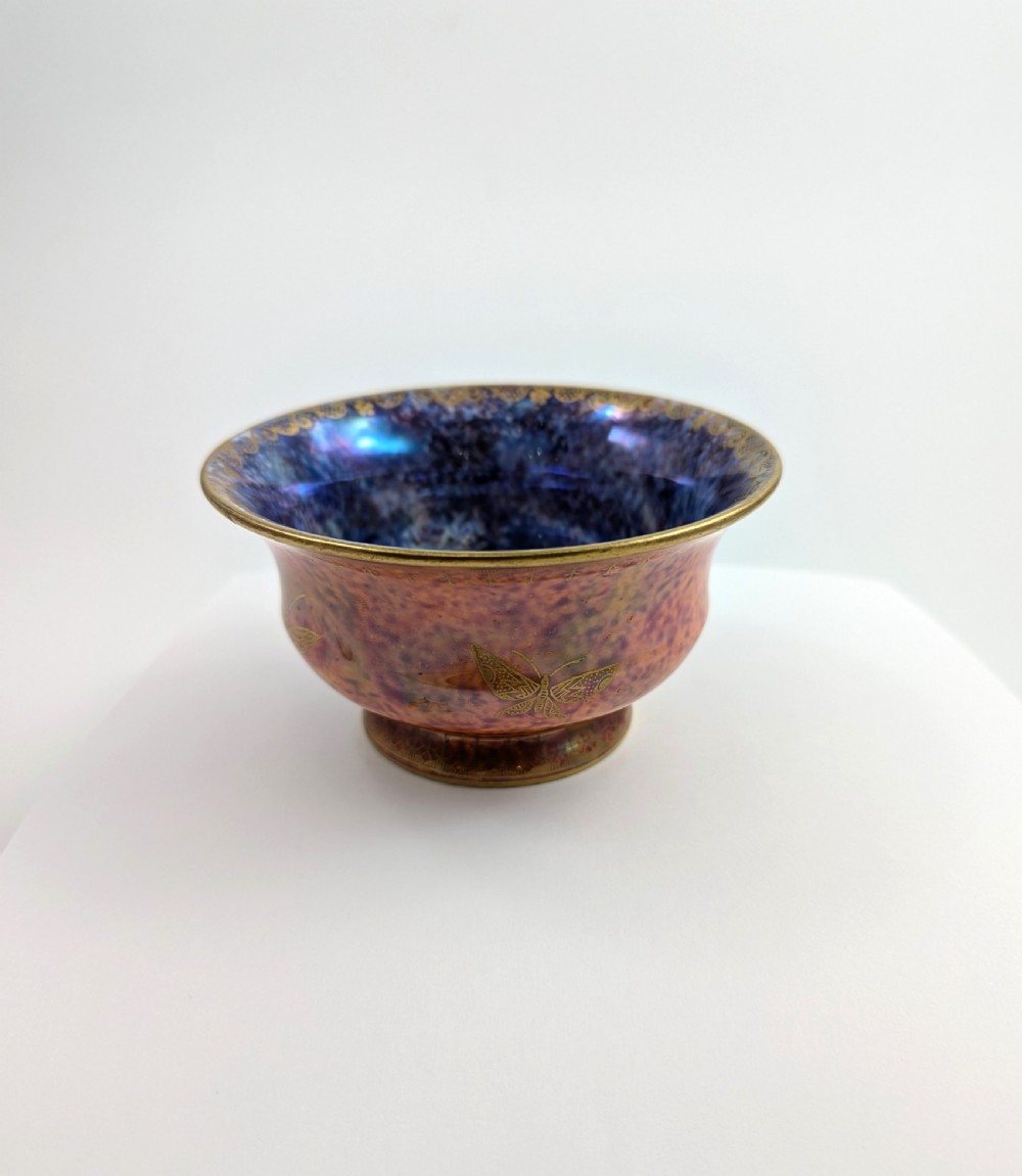 An antique Wedgwood ceramic bowl featuring a mottled orange and pink exterior with gilded butterfly motifs and an iridescent purple and blue interior glaze. View V