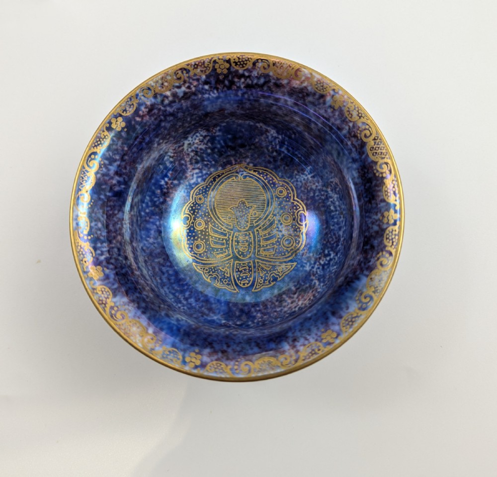 An antique Wedgwood ceramic bowl featuring a mottled orange and pink exterior with gilded butterfly motifs and an iridescent purple and blue interior glaze. View VII