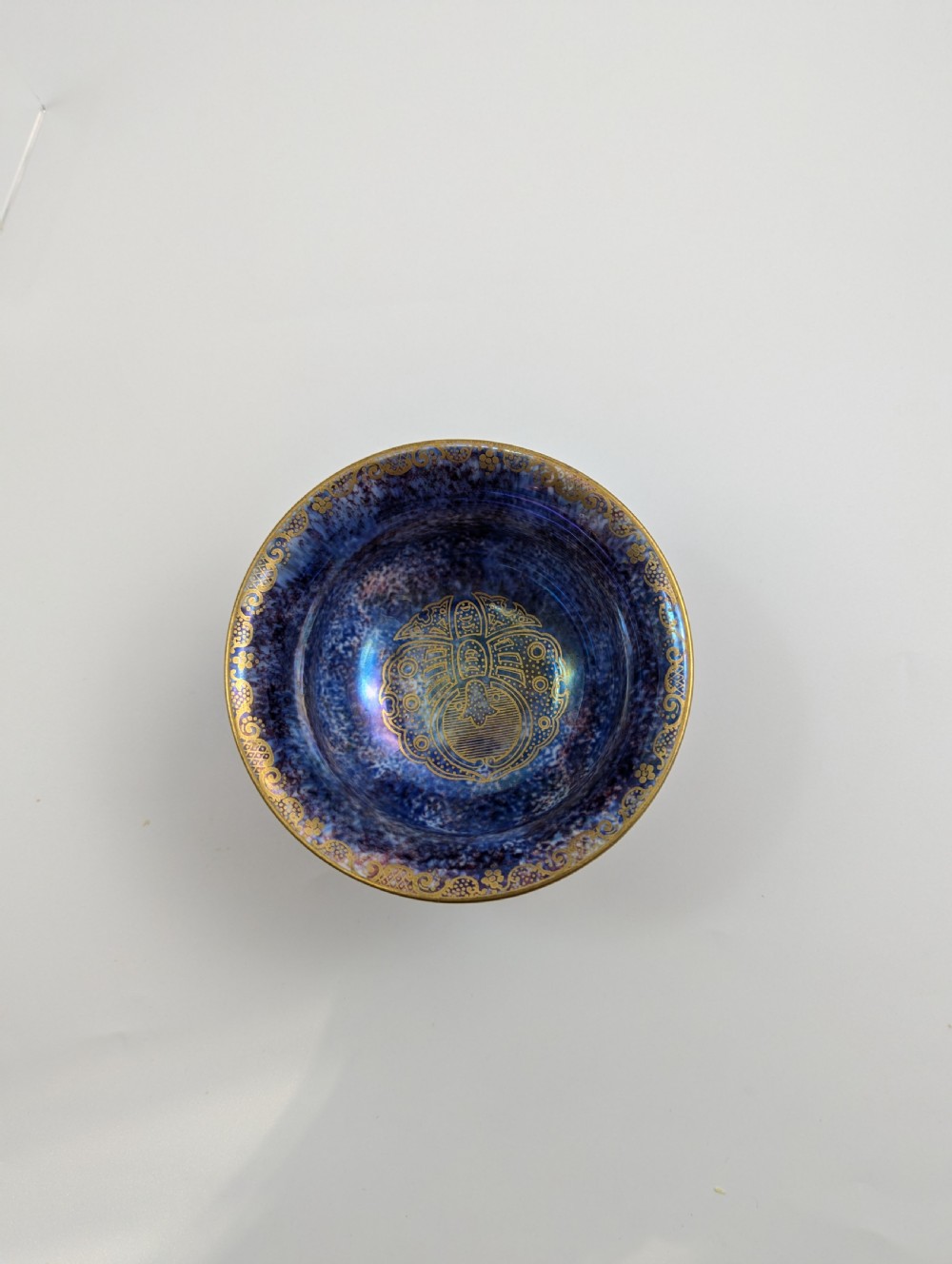An antique Wedgwood ceramic bowl featuring a mottled orange and pink exterior with gilded butterfly motifs and an iridescent purple and blue interior glaze. View VIII