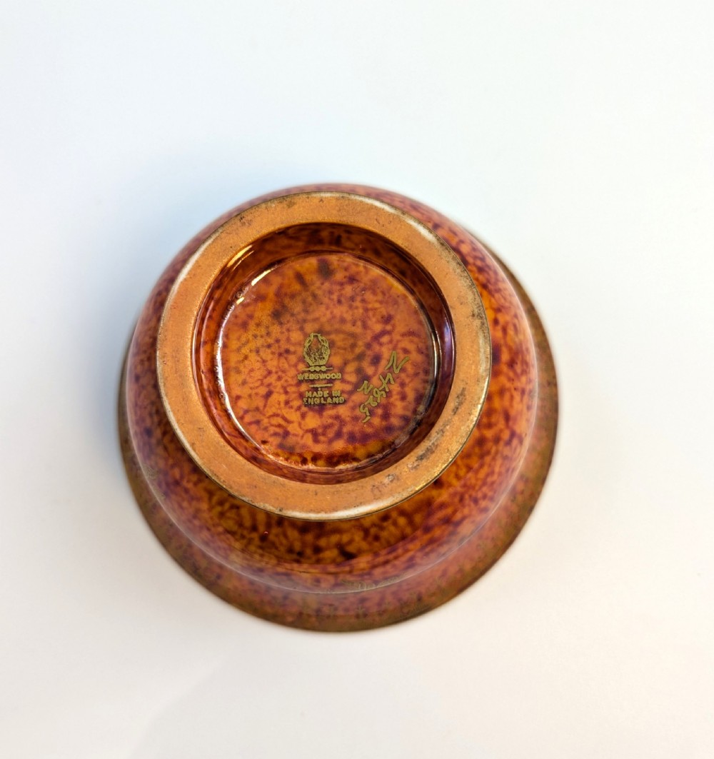 An antique Wedgwood ceramic bowl featuring a mottled orange and pink exterior with gilded butterfly motifs and an iridescent purple and blue interior glaze. View IX