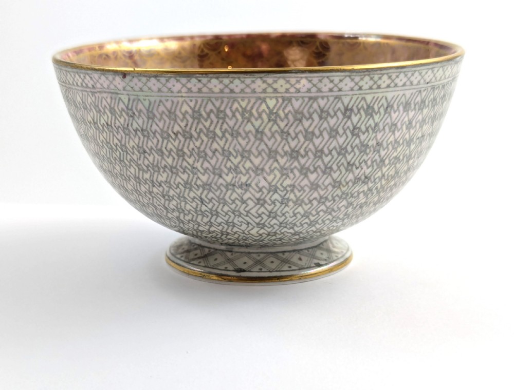 A small footed Wedgwood porcelain bowl featuring a grey diaper patterned exterior and a mottled orange lustre interior with gilt trim. View III
