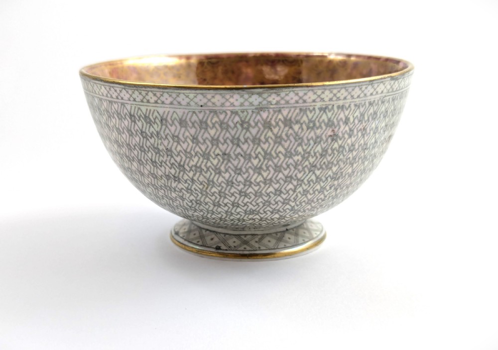A small footed Wedgwood porcelain bowl featuring a grey diaper patterned exterior and a mottled orange lustre interior with gilt trim. View IV