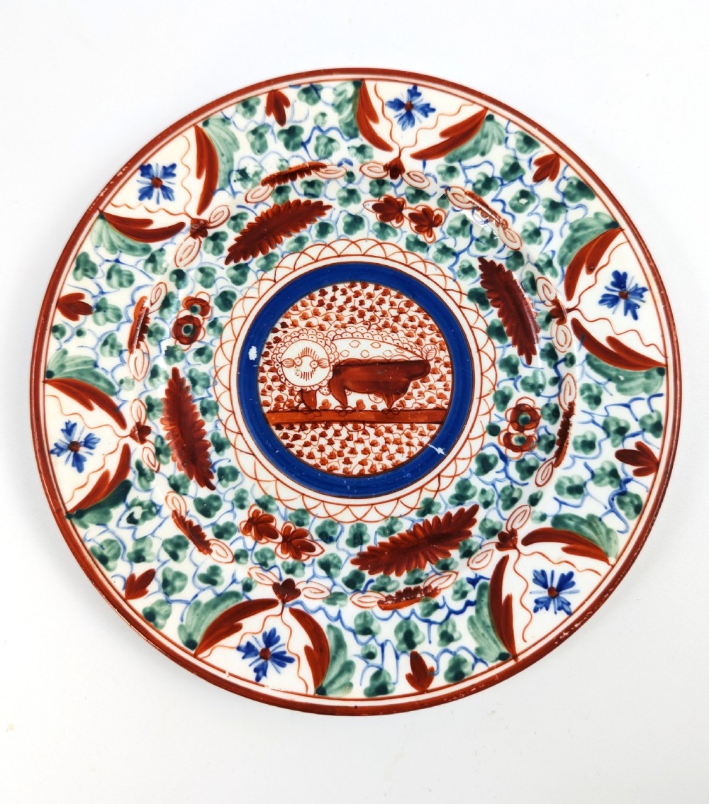 An early nineteenth-century Minton porcelain trio comprising a coffee can, saucer, and plate decorated with hand-painted terracotta, blue, and green floral and animal motifs. View III