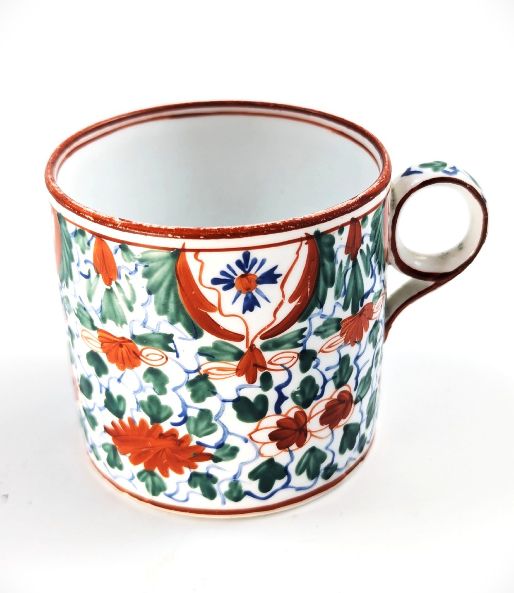 An early nineteenth-century Minton porcelain trio comprising a coffee can, saucer, and plate decorated with hand-painted terracotta, blue, and green floral and animal motifs. View VII