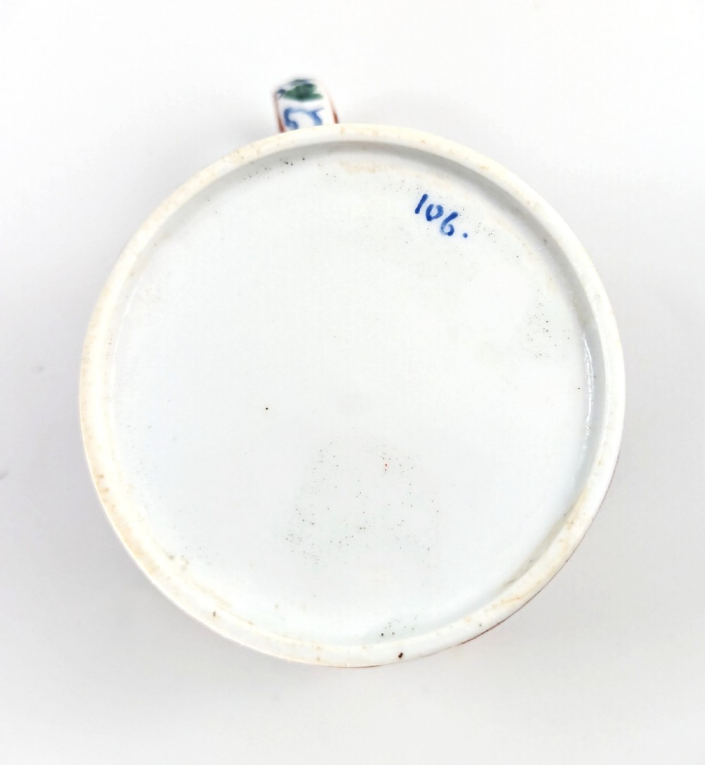 An early nineteenth-century Minton porcelain trio comprising a coffee can, saucer, and plate decorated with hand-painted terracotta, blue, and green floral and animal motifs. View XII