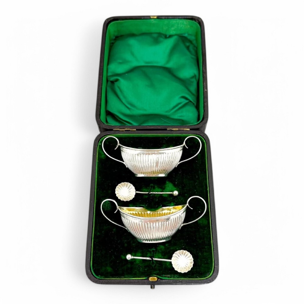 Pair of antique gilt sterling silver boxed navette salts with shell spoons, 1900
