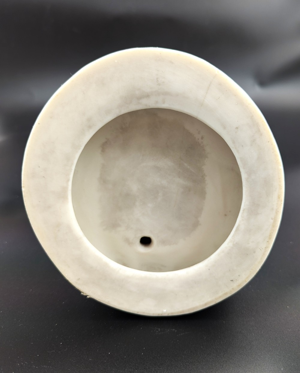 An off-white Parian porcelain figurine depicting a standing classical female figure holding a fruit basket on a circular base. View XIV