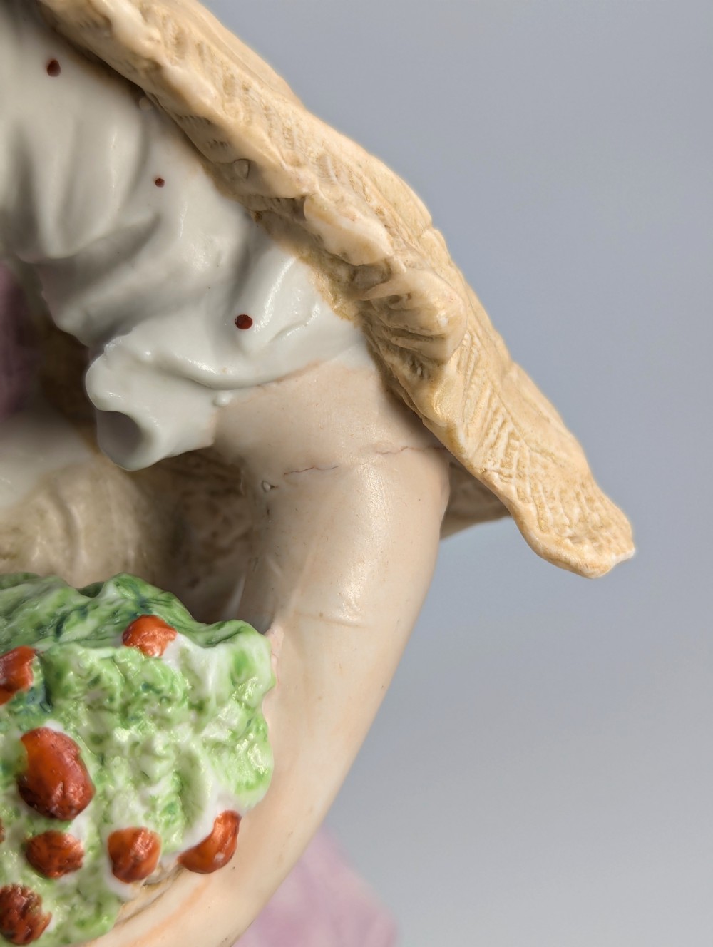 A pair of antique German bisque porcelain figurines depicting a man and woman in detailed pastoral attire with gilded accents on scroll bases. View VIII