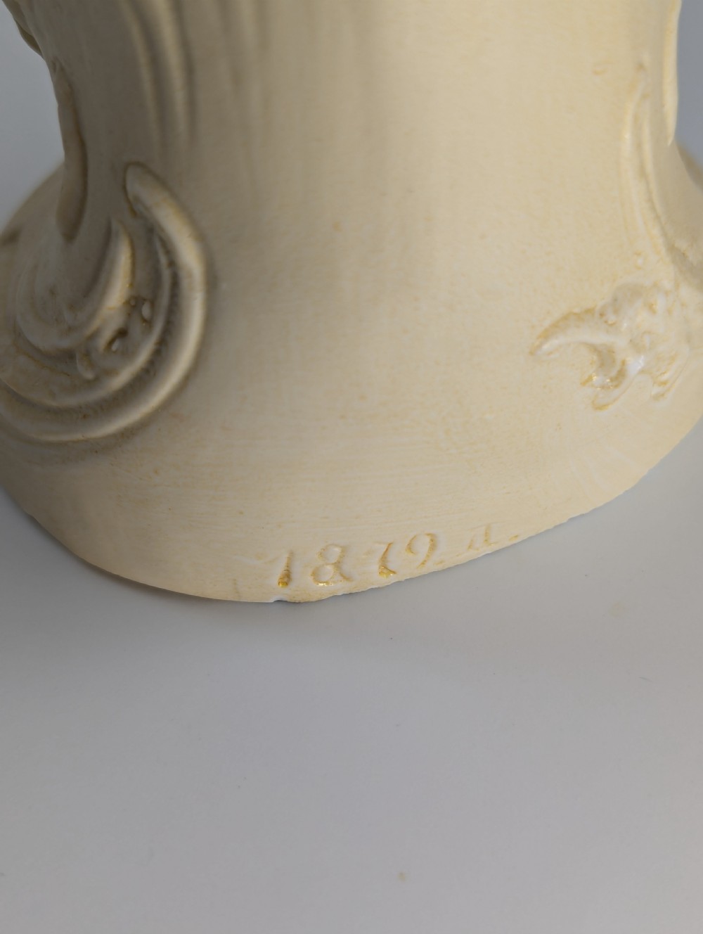A pair of antique German bisque porcelain figurines depicting a man and woman in detailed pastoral attire with gilded accents on scroll bases. View XII