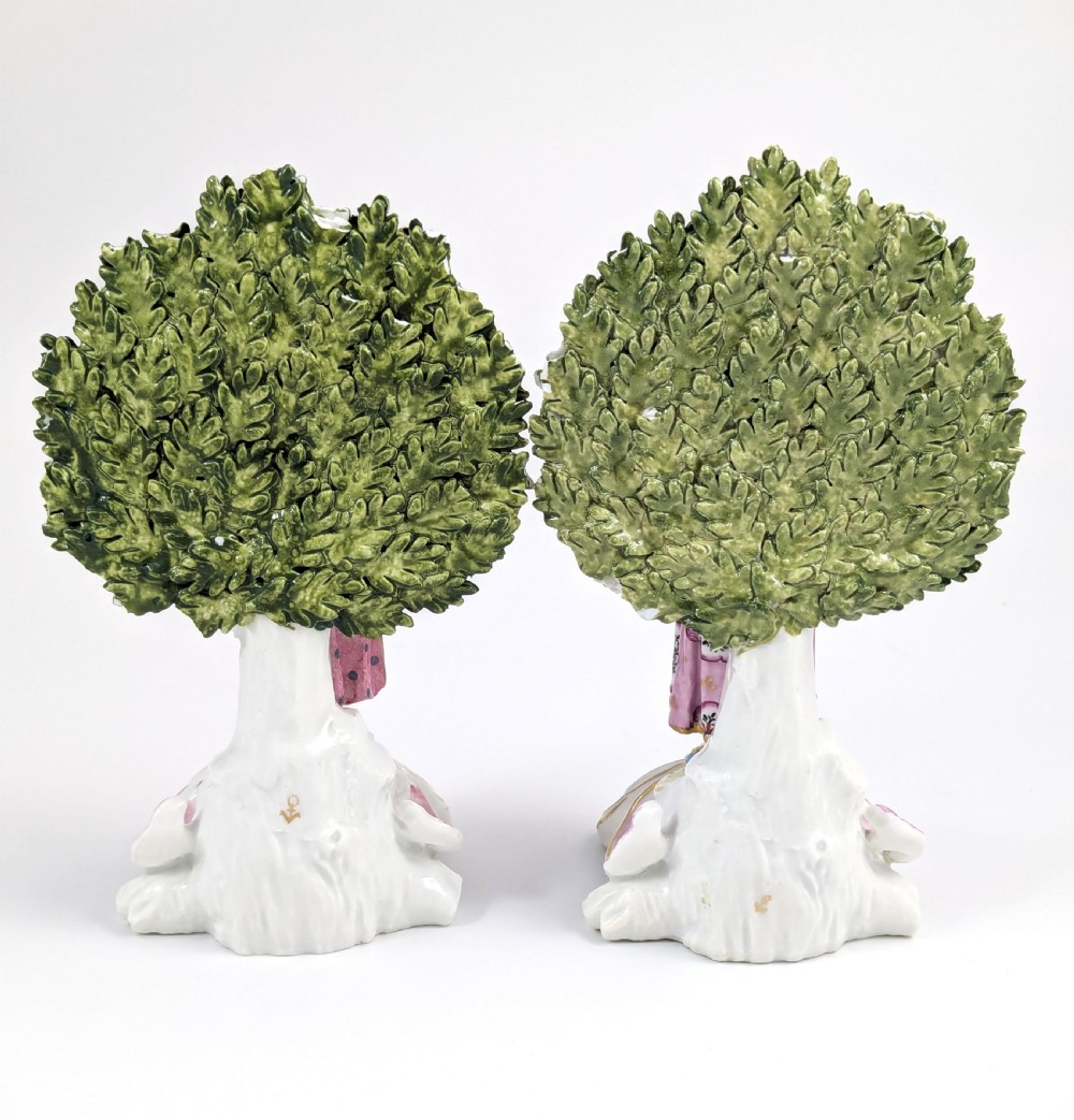 A pair of 19th-century Samson of Paris hand-painted porcelain figures standing against dense, flowering green bocage backgrounds on scrollwork bases. View III
