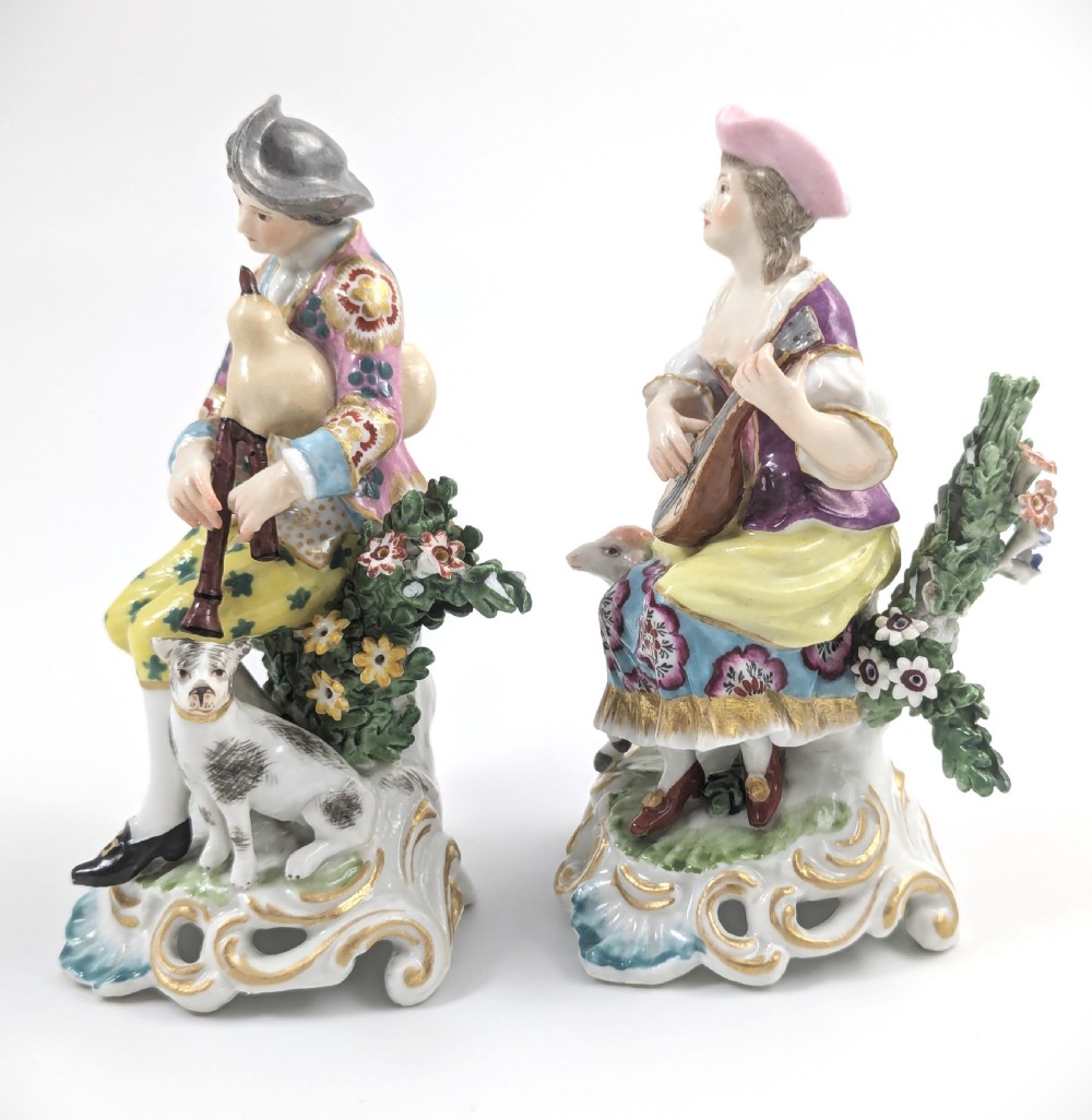 Pair of nineteenth-century Dresden porcelain figurines depicting a male bagpipe player with a dog and a female lute player with a lamb, both styled in Rococo attire on ornate bases. View II