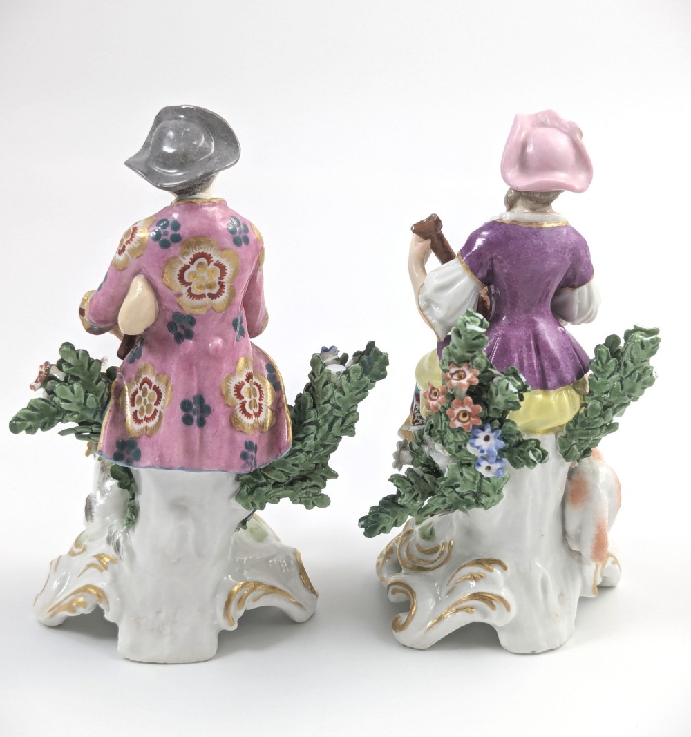 Pair of nineteenth-century Dresden porcelain figurines depicting a male bagpipe player with a dog and a female lute player with a lamb, both styled in Rococo attire on ornate bases. View III