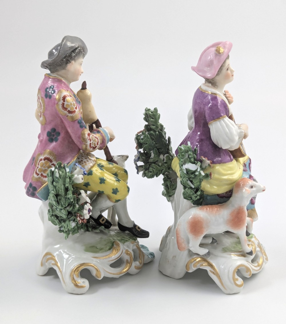 Pair of nineteenth-century Dresden porcelain figurines depicting a male bagpipe player with a dog and a female lute player with a lamb, both styled in Rococo attire on ornate bases. View IV