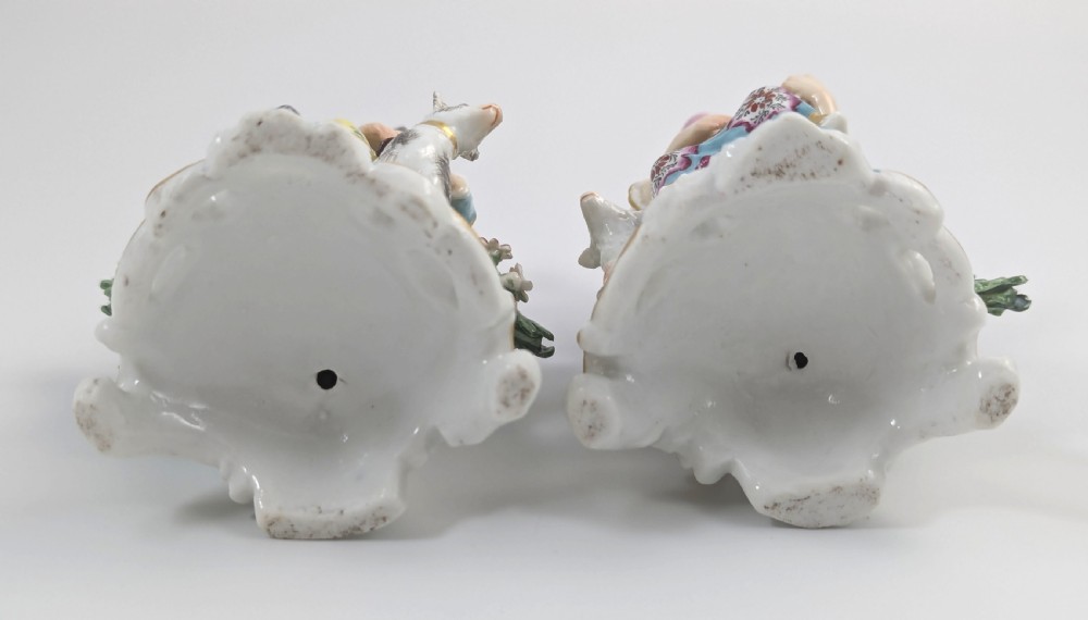 Pair of nineteenth-century Dresden porcelain figurines depicting a male bagpipe player with a dog and a female lute player with a lamb, both styled in Rococo attire on ornate bases. View V