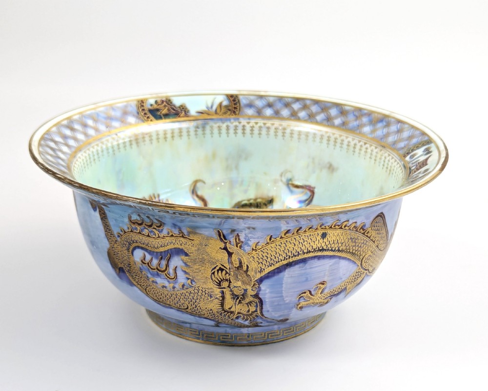 An antique light blue lustre porcelain bowl decorated with a detailed gilded dragon motif around the exterior. View IV