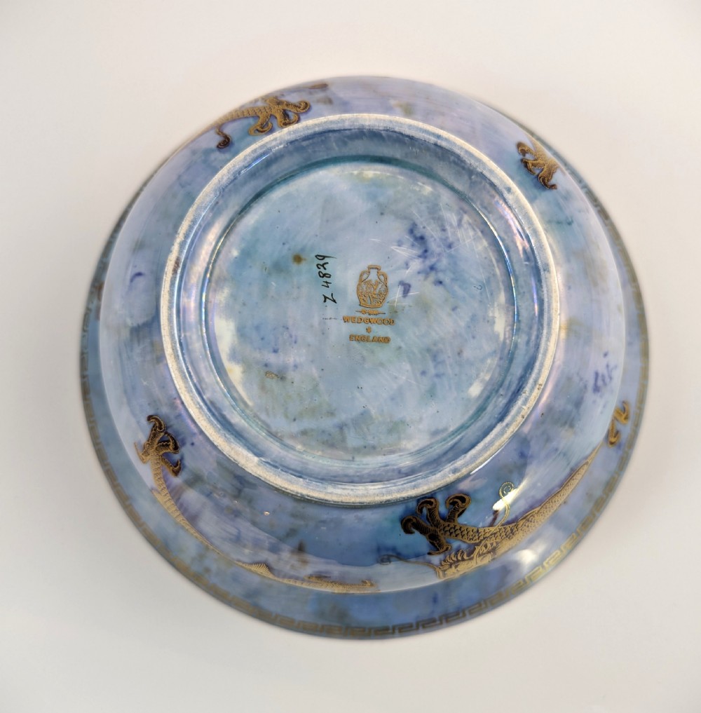 An antique light blue lustre porcelain bowl decorated with a detailed gilded dragon motif around the exterior. View VIII