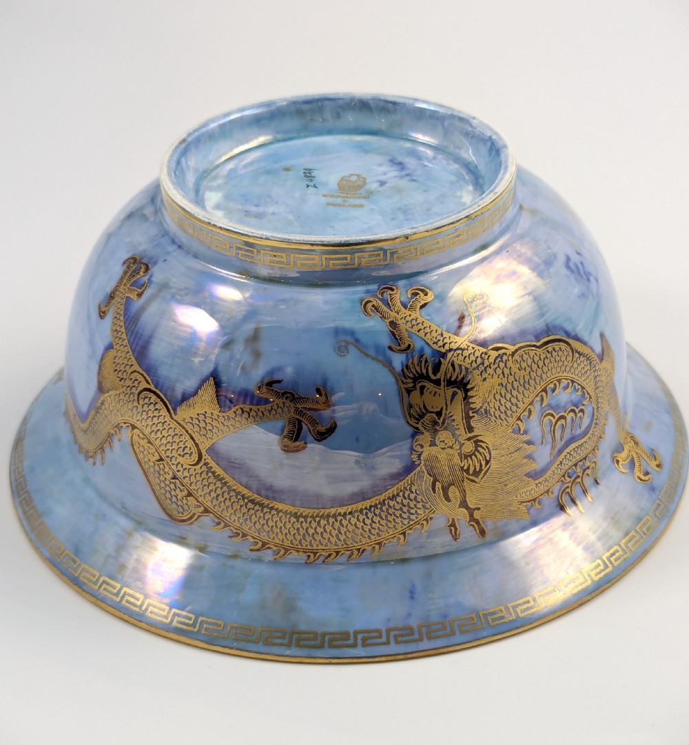 An antique light blue lustre porcelain bowl decorated with a detailed gilded dragon motif around the exterior. View X