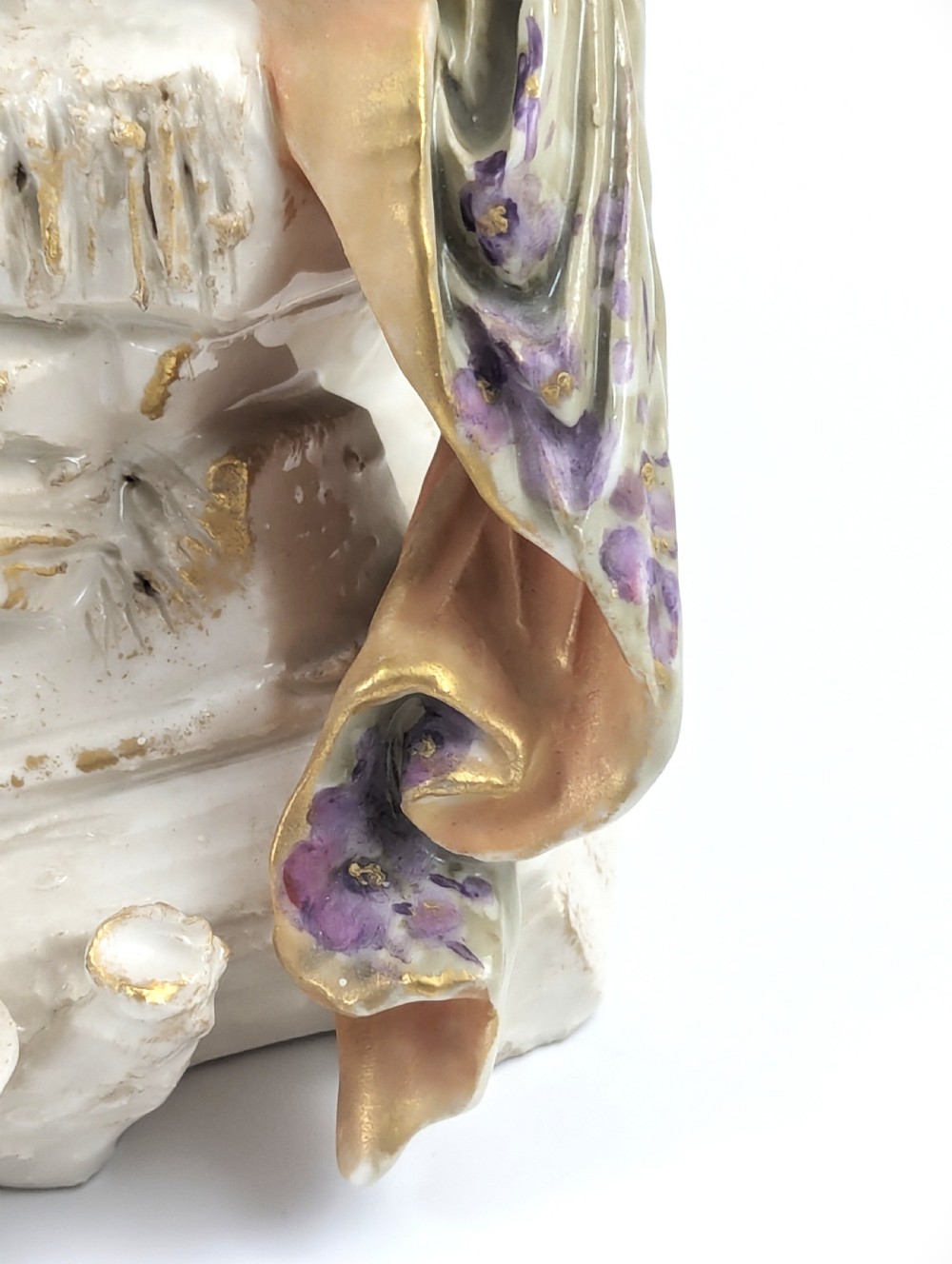 An Art Nouveau porcelain figurine depicting a standing maiden wrapped in a flowing scarf with a sage green dress on a naturalistic base. View X
