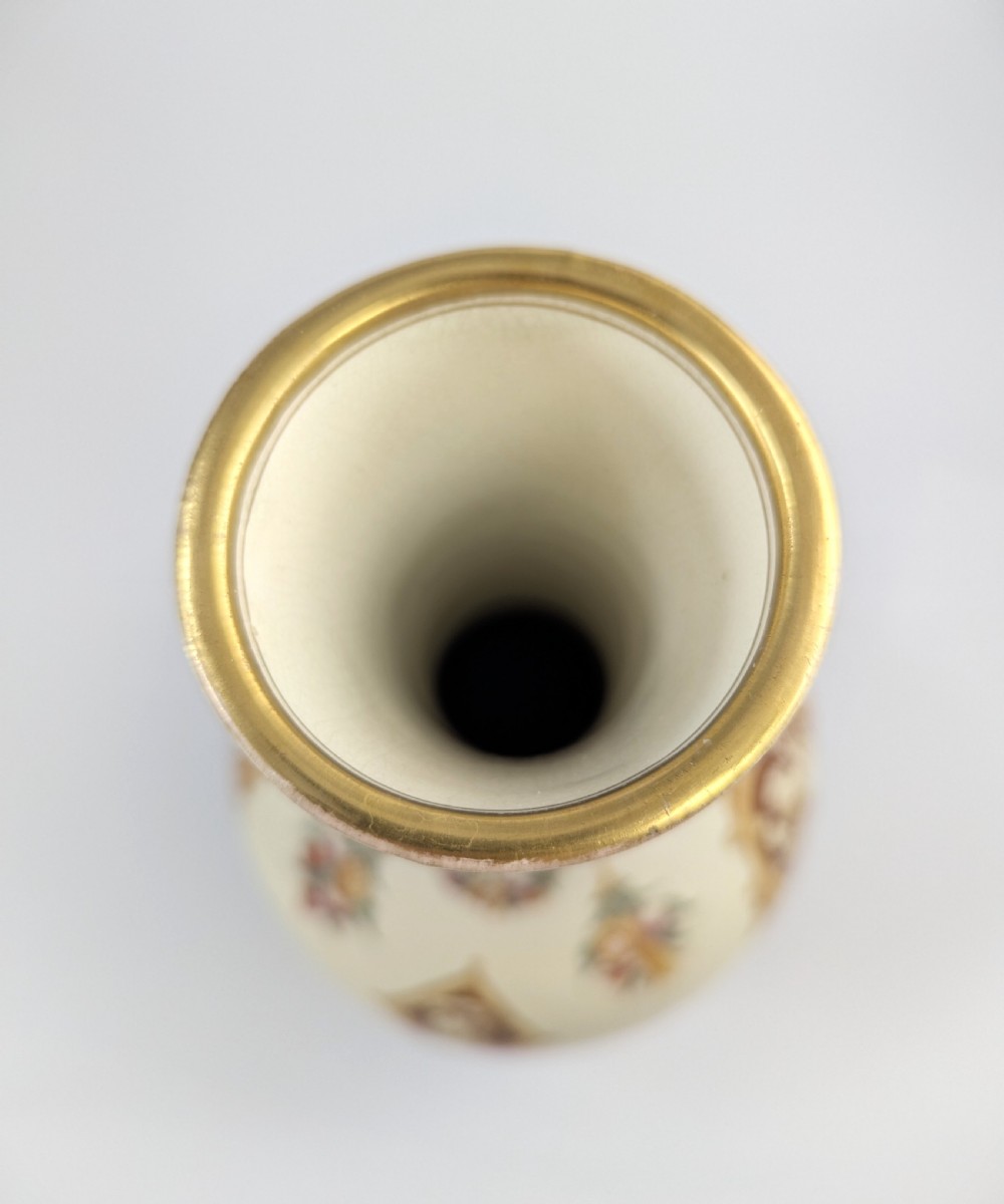 A late 19th-century Wedgwood ceramic vase featuring a slender neck, bulbous body decorated with classical cartouches and gilt details, resting on a carved relief base. View IX