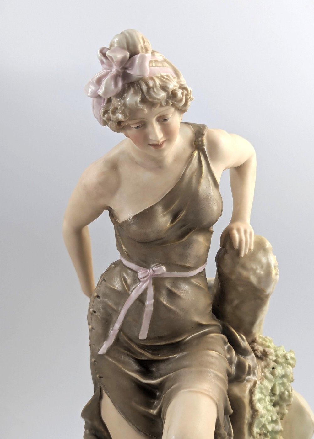 An Art Nouveau Royal Dux porcelain centrepiece depicting a draped female bather standing atop rockwork above a large shell-shaped basin. View IX