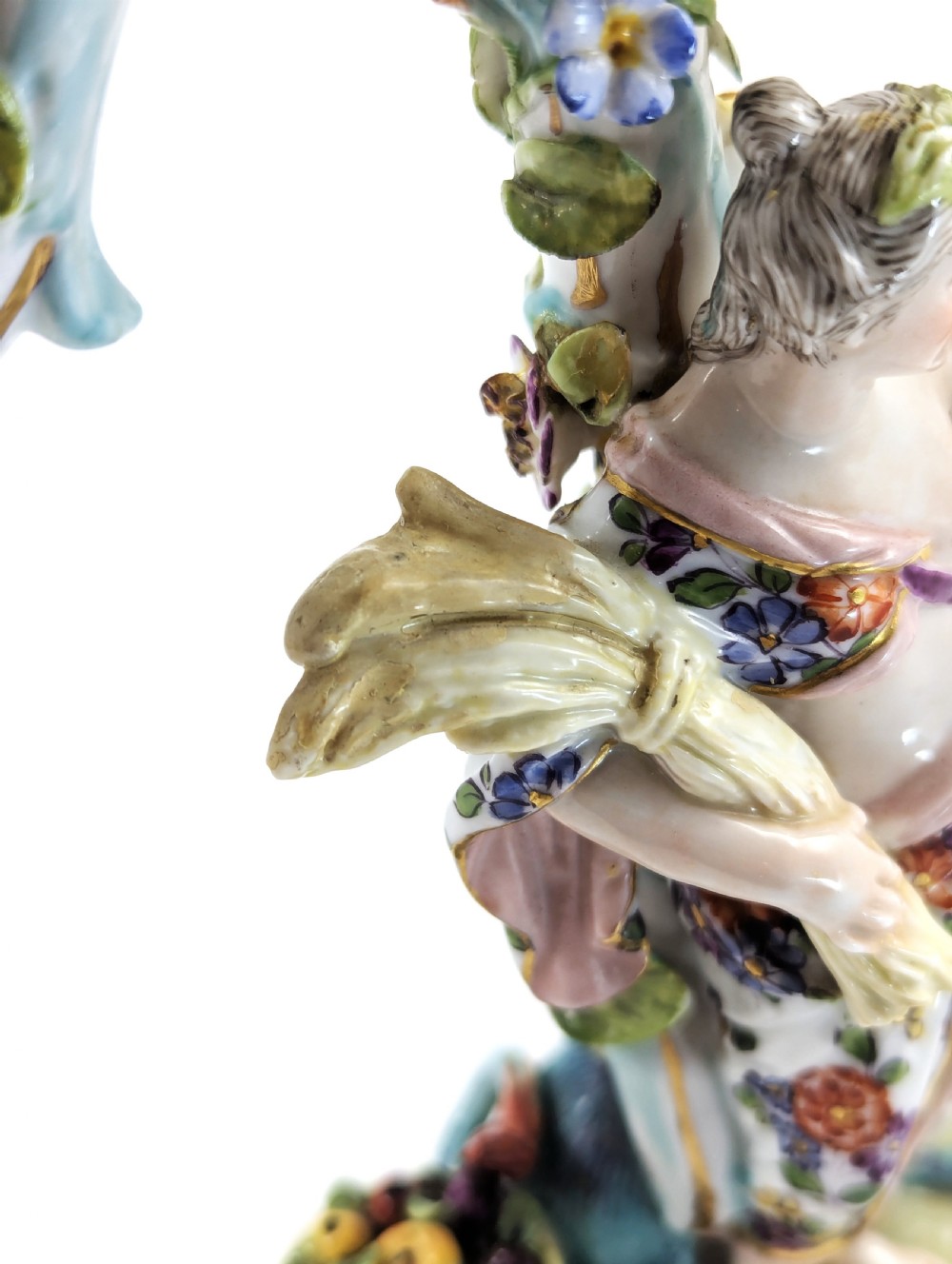 A nineteenth-century Dresden porcelain three-light candelabra featuring a central allegorical figure draped in floral fabric standing on a gilded Rococo base surrounded by encrusted porcelain flowers. View XIII