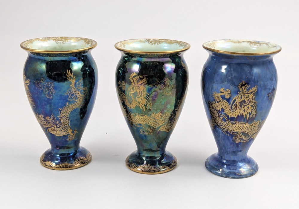 A trio of small blue iridescent ceramic bud vases featuring gilded dragon motifs and flared upper rims. View II