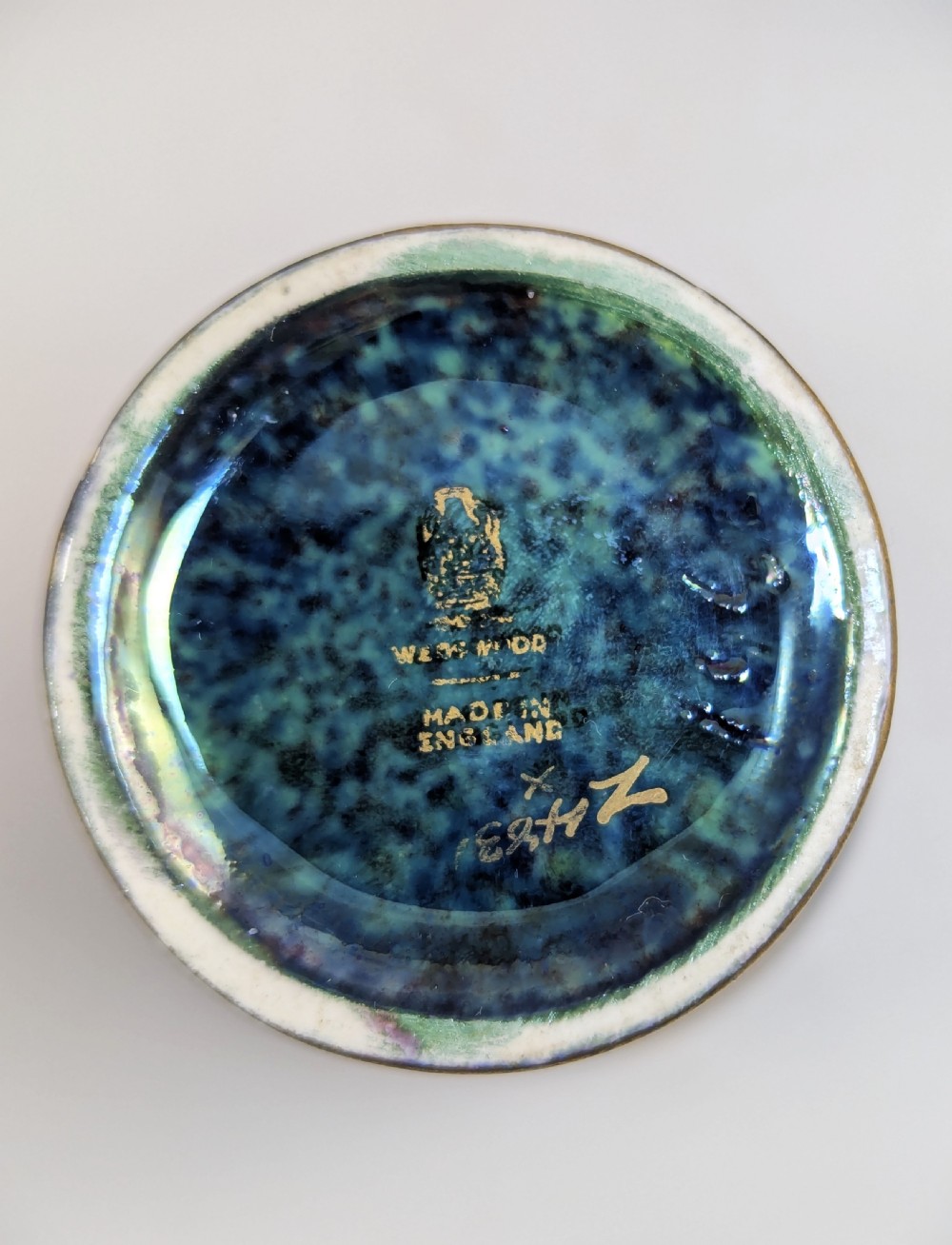 A trio of small blue iridescent ceramic bud vases featuring gilded dragon motifs and flared upper rims. View VIII