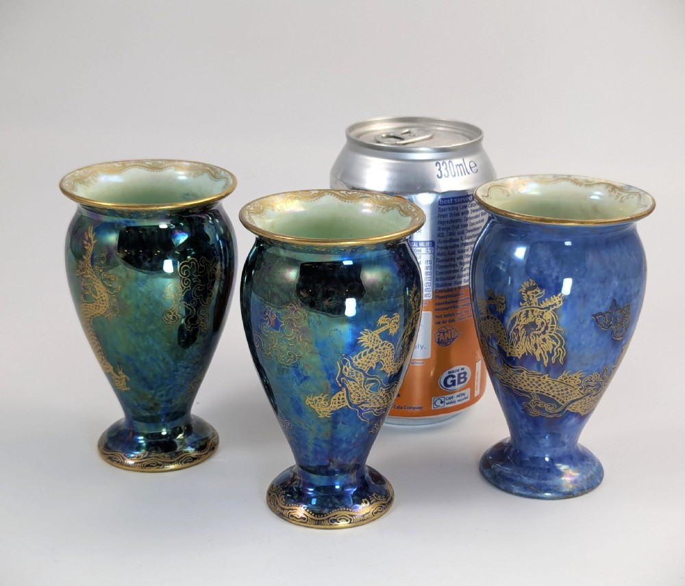 A trio of small blue iridescent ceramic bud vases featuring gilded dragon motifs and flared upper rims. View IX