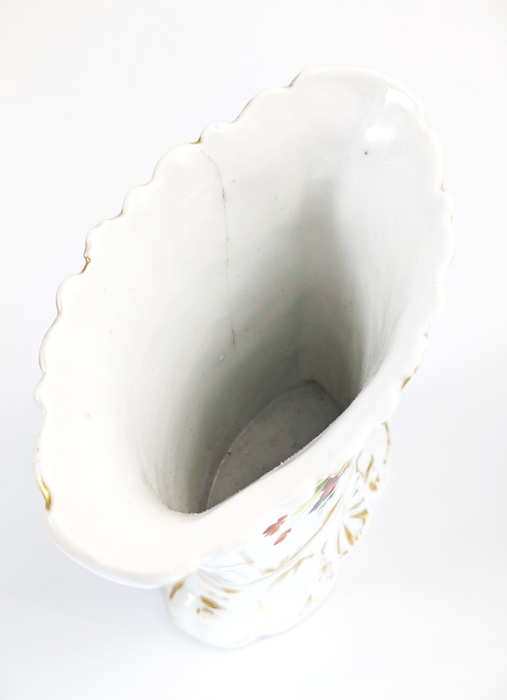 A white hard-paste porcelain vase featuring a flared scalloped rim, hand-painted floral display, and gilded Rococo scroll accents. View VI