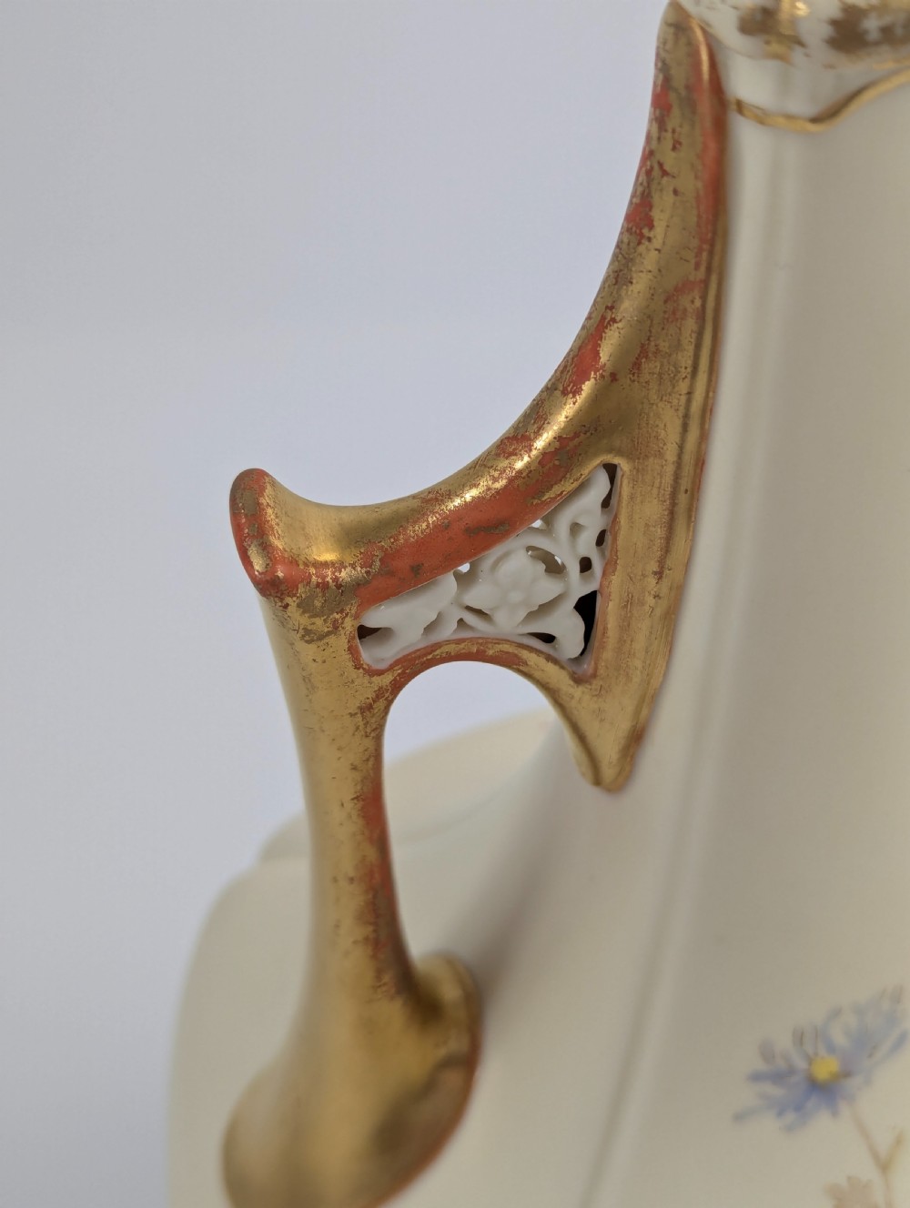 An antique cream Royal Worcester porcelain vase featuring hand-painted chrysanthemums, an elongated neck, and pierced gilded handles. View VIII