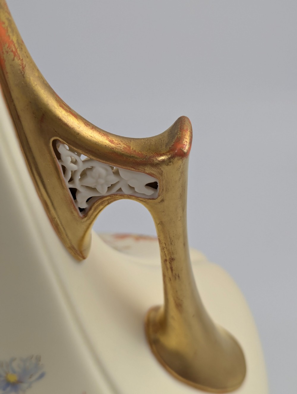 An antique cream Royal Worcester porcelain vase featuring hand-painted chrysanthemums, an elongated neck, and pierced gilded handles. View IX
