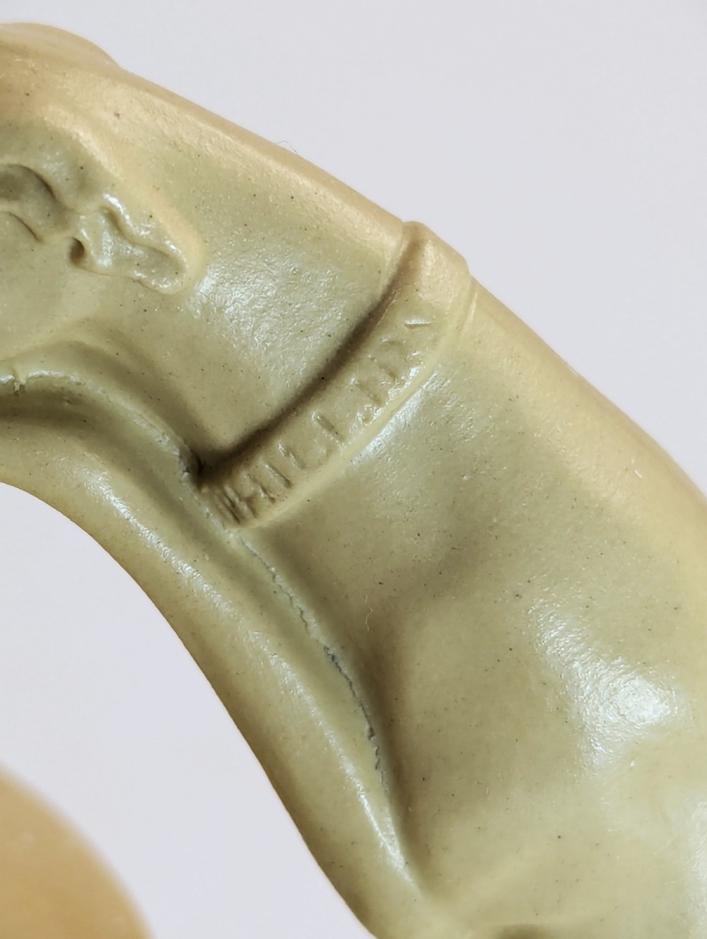A graduated set of three buff yellow Regency ceramic pitchers featuring relief-moulded stag hunting scenes and sculpted hound handles. View XIII