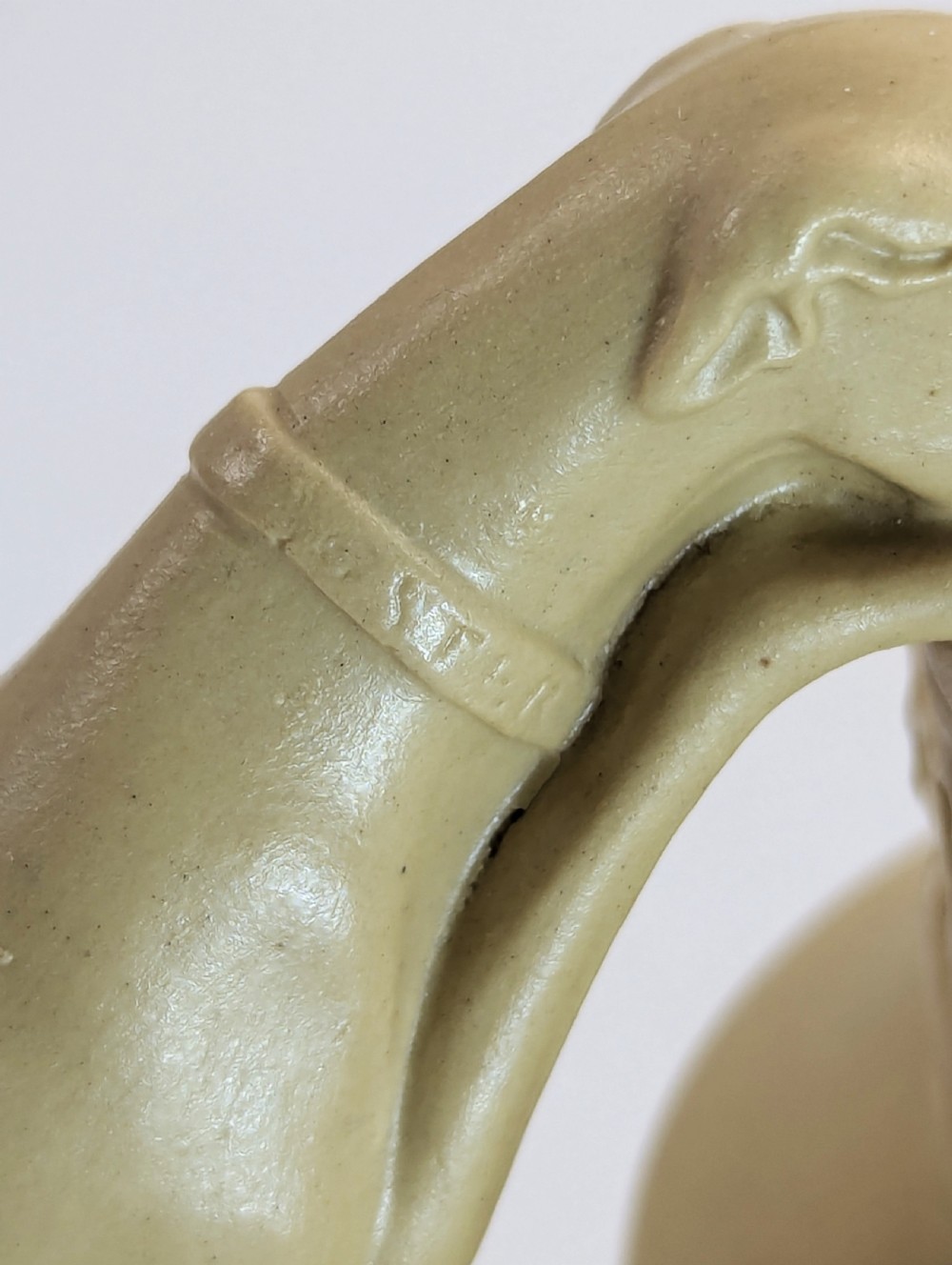 A graduated set of three buff yellow Regency ceramic pitchers featuring relief-moulded stag hunting scenes and sculpted hound handles. View XIV