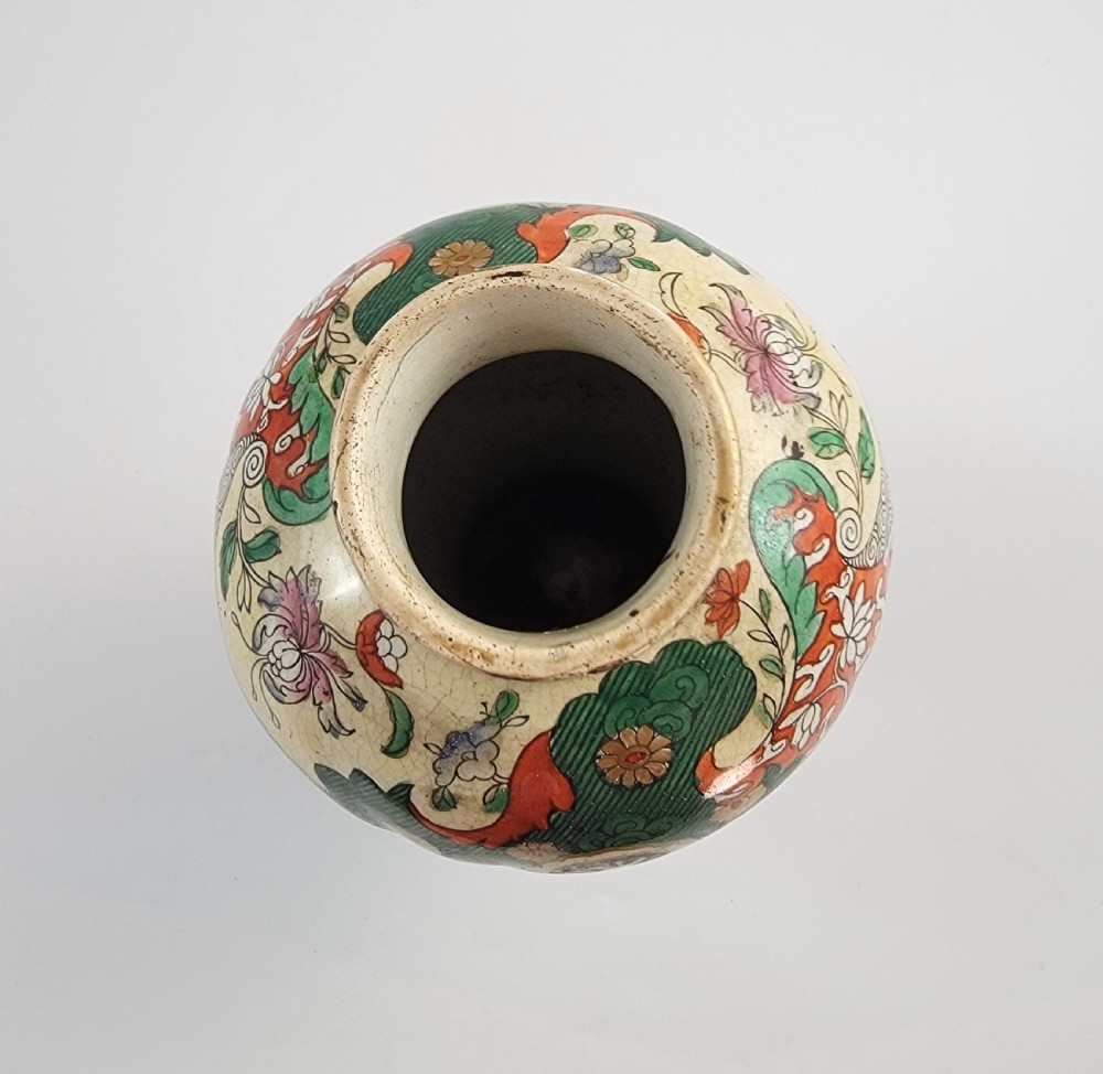 A Regency period baluster-shaped Miles Mason ironstone vase featuring an orange background with intricate hand-painted Chinoiserie floral patterns and polychrome enamel detailing. View II
