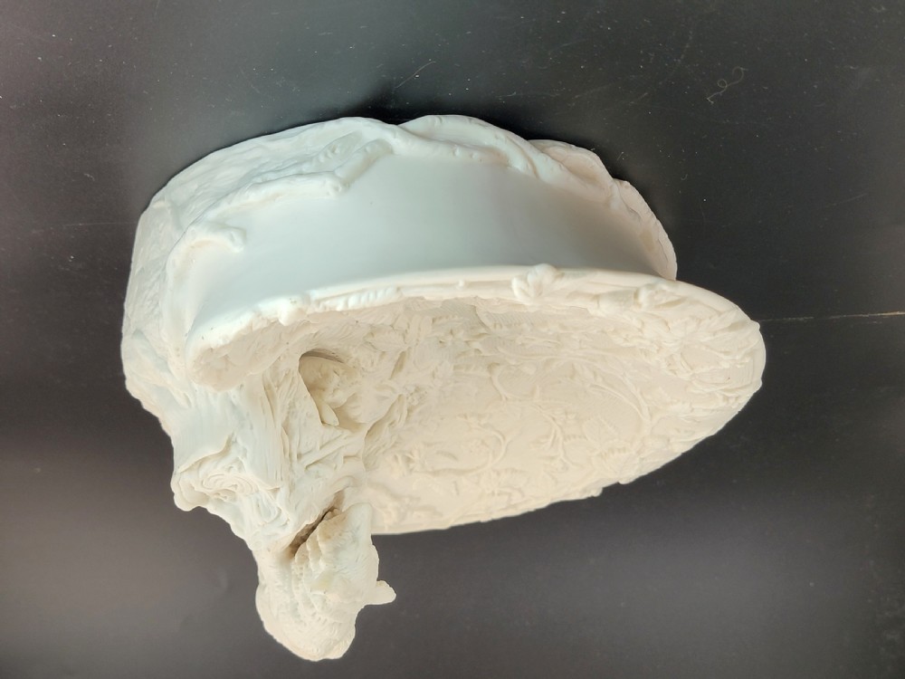 An off-white Parian porcelain centrepiece dish featuring a sculpted fox perched on a central stump above a rabbit in a hollow base surrounded by leaves. View III
