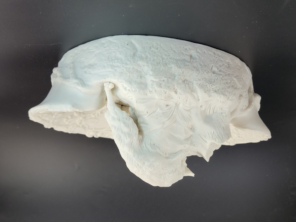 An off-white Parian porcelain centrepiece dish featuring a sculpted fox perched on a central stump above a rabbit in a hollow base surrounded by leaves. View V