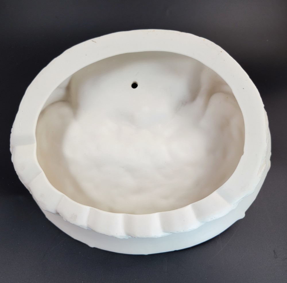 An off-white Parian porcelain centrepiece dish featuring a sculpted fox perched on a central stump above a rabbit in a hollow base surrounded by leaves. View IX