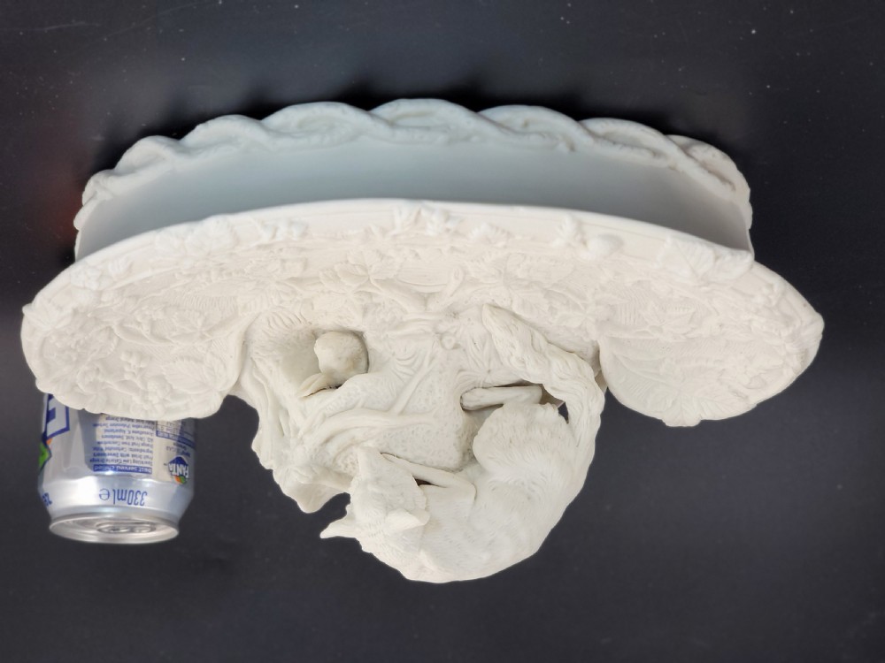An off-white Parian porcelain centrepiece dish featuring a sculpted fox perched on a central stump above a rabbit in a hollow base surrounded by leaves. View X