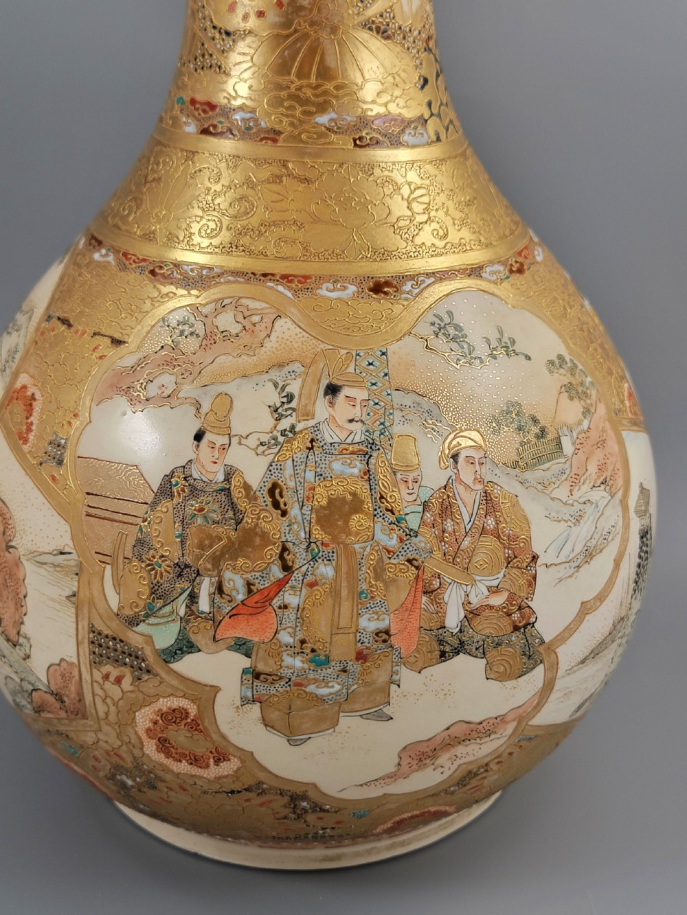A Japanese Satsuma earthenware vase featuring a bulbous garlic-shaped mouth, intricate gilded borders, and painted panels depicting samurai warriors. View VII