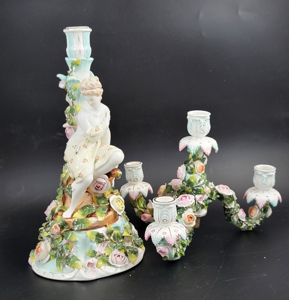 A Sitzendorf porcelain four-light candelabra featuring a seated female figure, encrusted roses, foliage, and three scrolling branch arms. View XIV